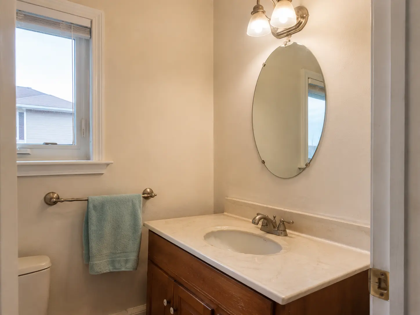 Bathroom before refresh with outdated fixtures and tired finishes