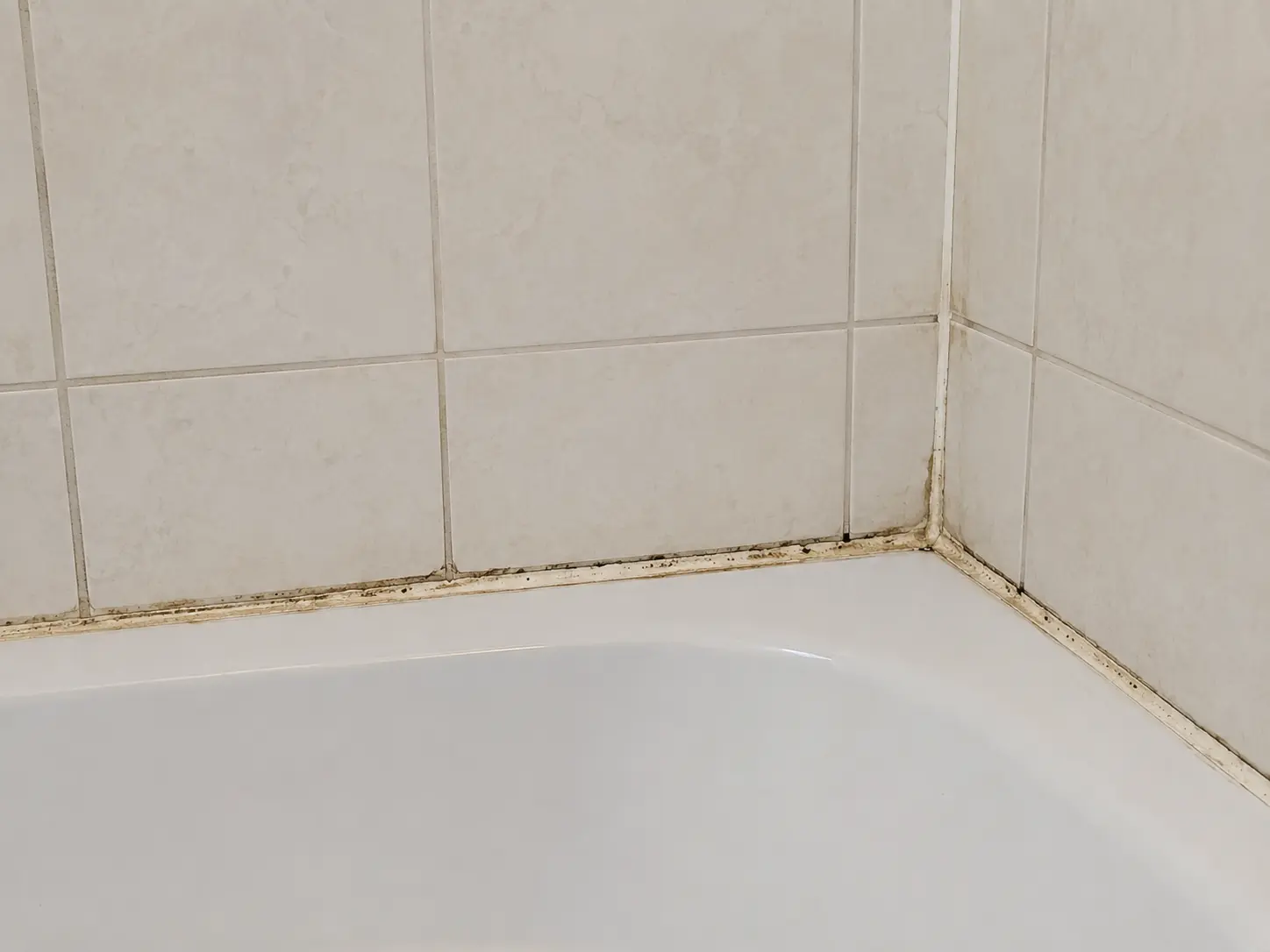 Old cracked caulk before replacement